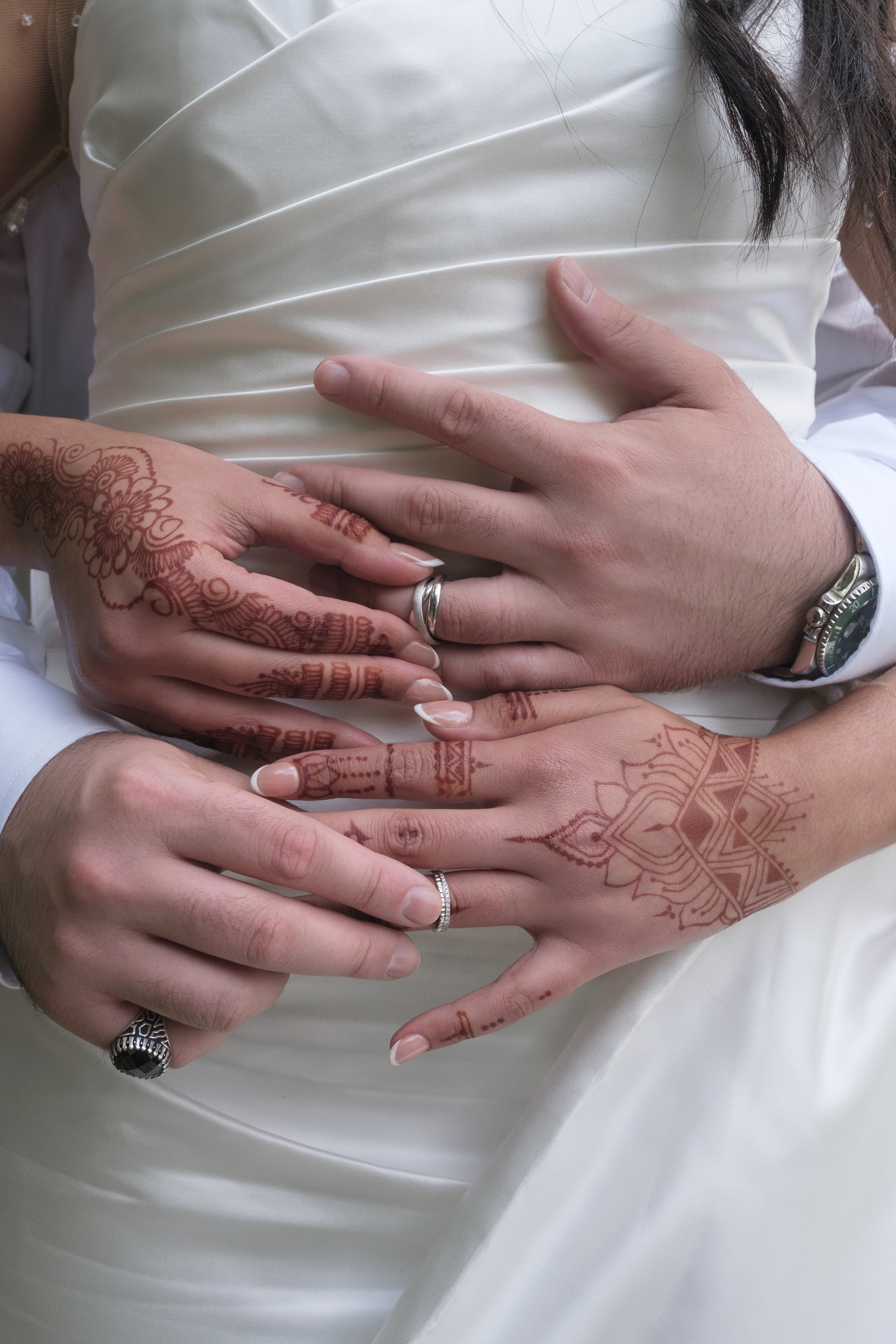 Mains des mariés entrelacées avec alliances et henné, photo symbolique par Michel Rouabah, photographe de mariage au Perreux-sur-Marne (Val-de-Marne, 94)